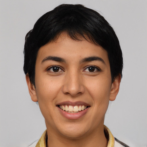 Joyful latino young-adult female with short  black hair and brown eyes