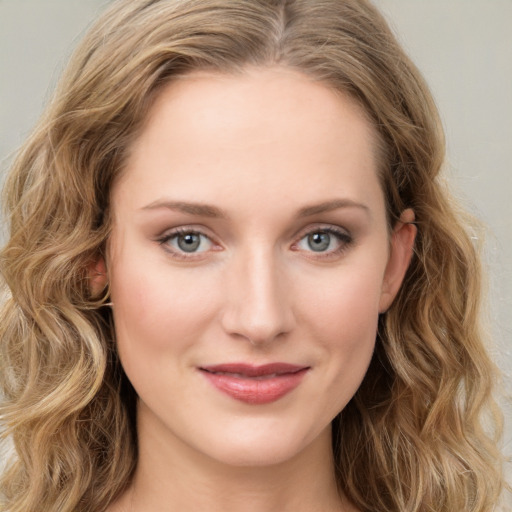 Joyful white young-adult female with long  brown hair and green eyes