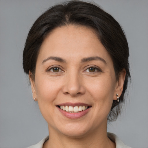 Joyful white adult female with medium  brown hair and brown eyes