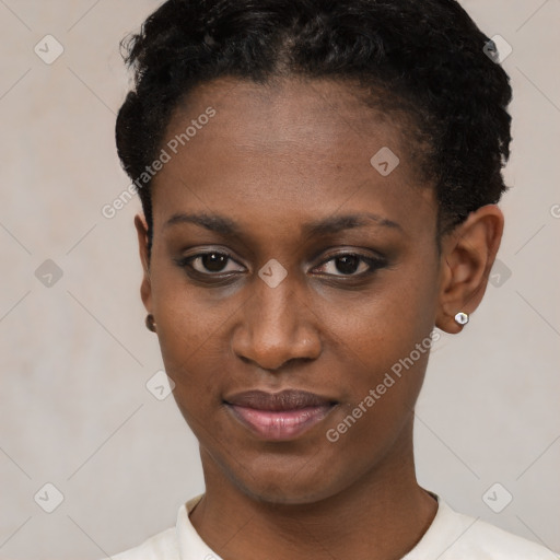 Joyful black young-adult female with short  black hair and brown eyes