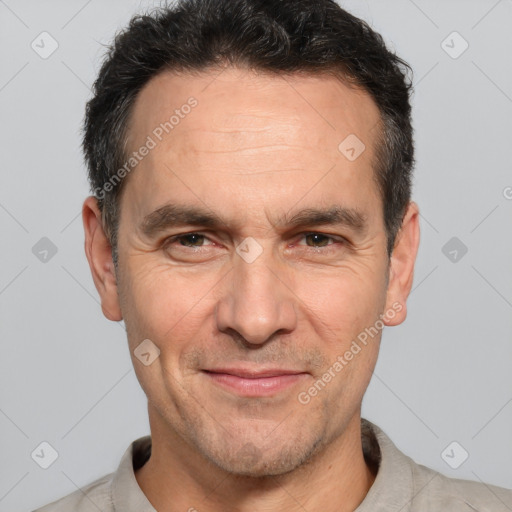 Joyful white adult male with short  brown hair and brown eyes