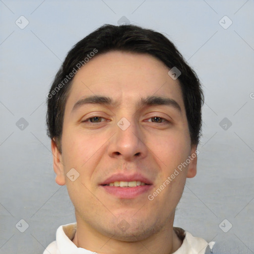 Joyful white young-adult male with short  black hair and brown eyes