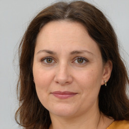 Joyful white adult female with long  brown hair and brown eyes