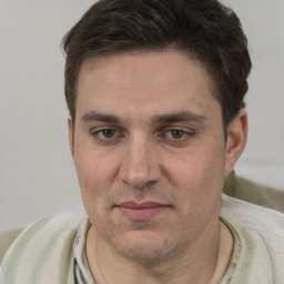 Joyful white adult male with short  brown hair and brown eyes