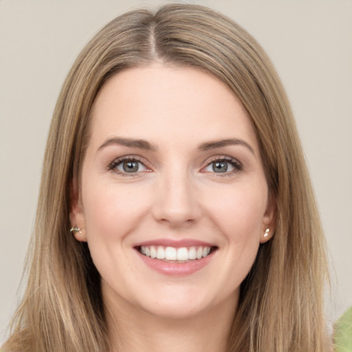 Joyful white young-adult female with long  brown hair and green eyes