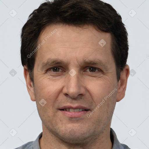 Joyful white adult male with short  brown hair and brown eyes