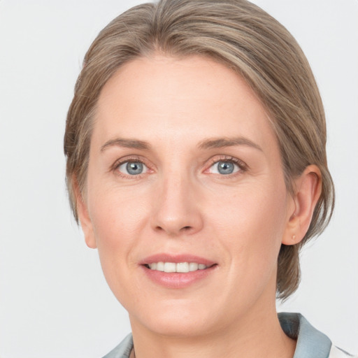 Joyful white adult female with medium  brown hair and grey eyes