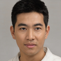 Joyful asian young-adult male with short  black hair and brown eyes