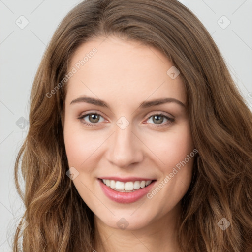 Joyful white young-adult female with long  brown hair and green eyes