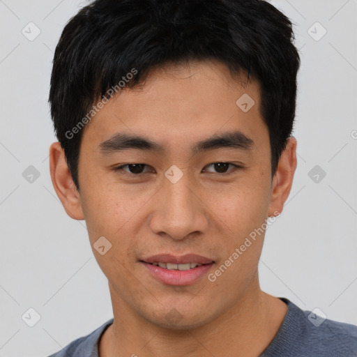 Joyful asian young-adult male with short  black hair and brown eyes