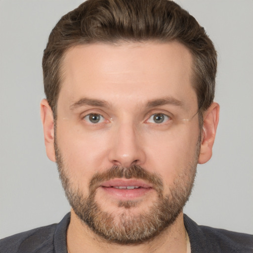 Joyful white adult male with short  brown hair and brown eyes