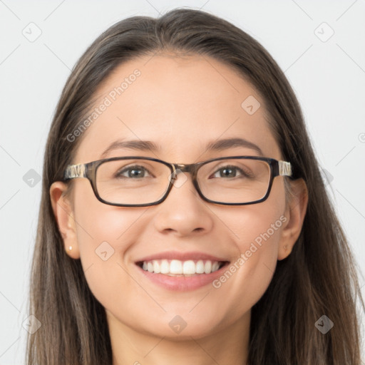 Joyful white young-adult female with long  brown hair and brown eyes