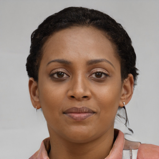 Joyful black young-adult female with short  brown hair and brown eyes
