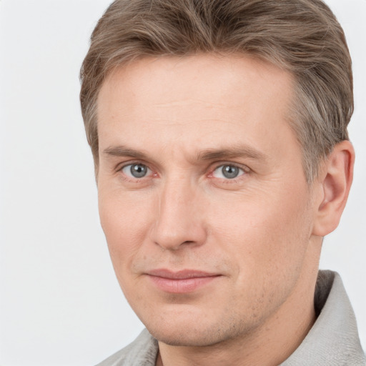 Joyful white adult male with short  brown hair and grey eyes