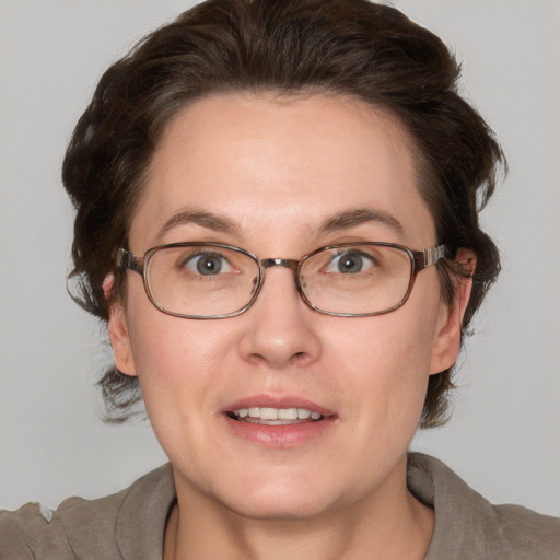 Joyful white adult female with medium  brown hair and grey eyes