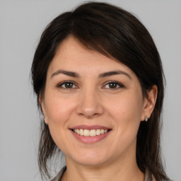 Joyful white young-adult female with medium  brown hair and brown eyes