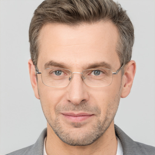 Joyful white adult male with short  brown hair and brown eyes