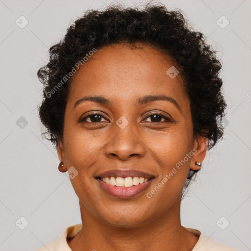 Joyful black adult female with short  brown hair and brown eyes