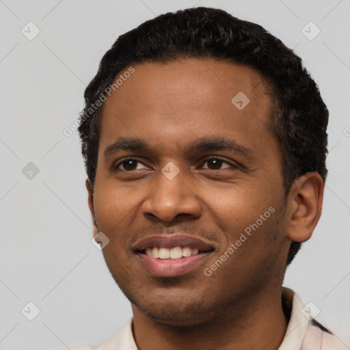 Joyful black young-adult male with short  black hair and brown eyes