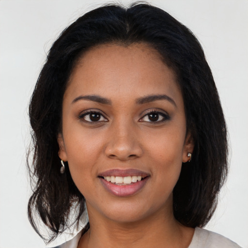 Joyful black young-adult female with medium  brown hair and brown eyes