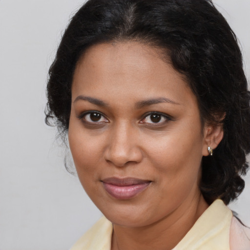 Joyful black young-adult female with medium  brown hair and brown eyes