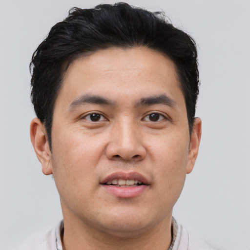Joyful asian young-adult male with short  brown hair and brown eyes