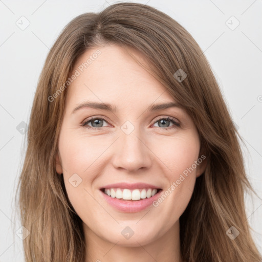 Joyful white young-adult female with long  brown hair and grey eyes