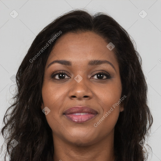 Joyful black young-adult female with long  brown hair and brown eyes