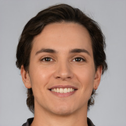 Joyful white young-adult male with medium  brown hair and brown eyes