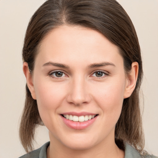 Joyful white young-adult female with medium  brown hair and brown eyes