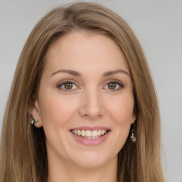 Joyful white young-adult female with long  brown hair and green eyes