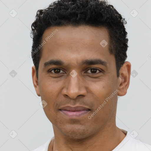 Joyful black young-adult male with short  black hair and brown eyes
