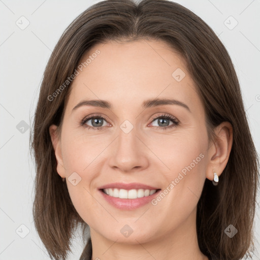 Joyful white young-adult female with medium  brown hair and grey eyes