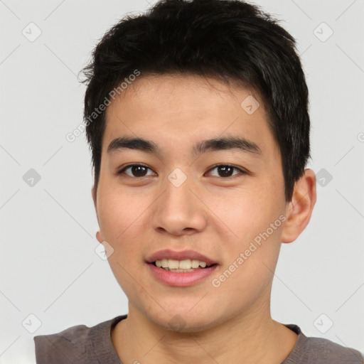 Joyful asian young-adult male with short  brown hair and brown eyes