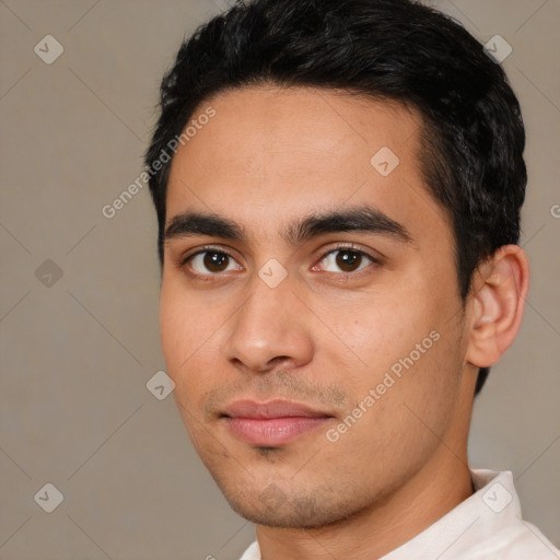 Joyful latino young-adult male with short  black hair and brown eyes