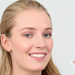 Joyful white young-adult female with long  brown hair and blue eyes