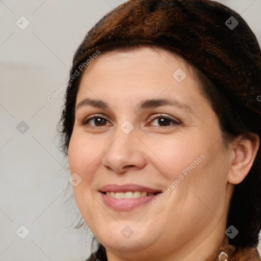 Joyful white adult female with medium  brown hair and brown eyes