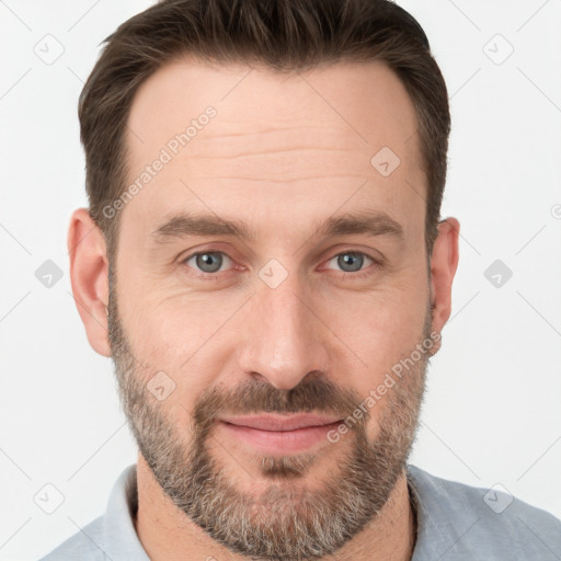 Joyful white adult male with short  brown hair and grey eyes