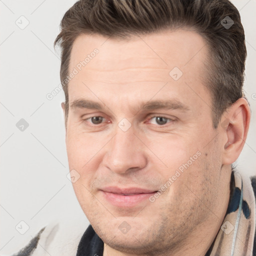 Joyful white adult male with short  brown hair and brown eyes