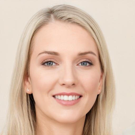 Joyful white young-adult female with long  brown hair and blue eyes