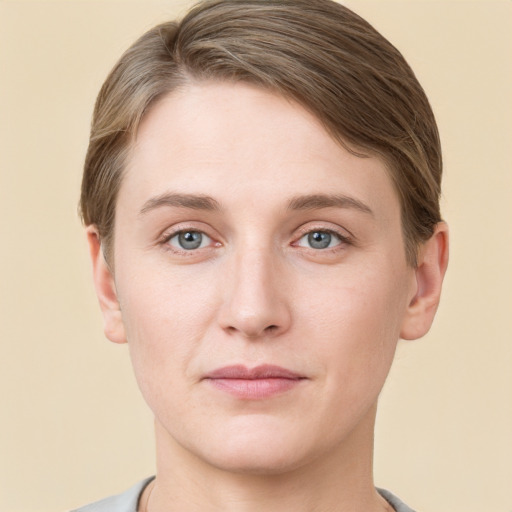 Joyful white young-adult female with short  brown hair and grey eyes