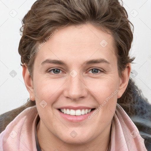 Joyful white young-adult female with long  brown hair and grey eyes