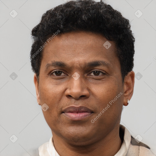 Joyful black adult male with short  brown hair and brown eyes