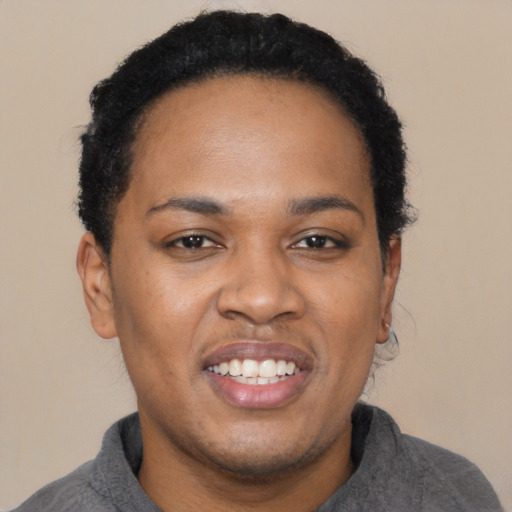 Joyful black young-adult male with short  black hair and brown eyes