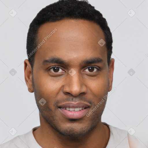 Joyful black young-adult male with short  black hair and brown eyes