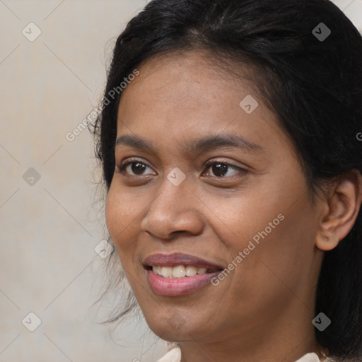 Joyful latino young-adult female with medium  brown hair and brown eyes