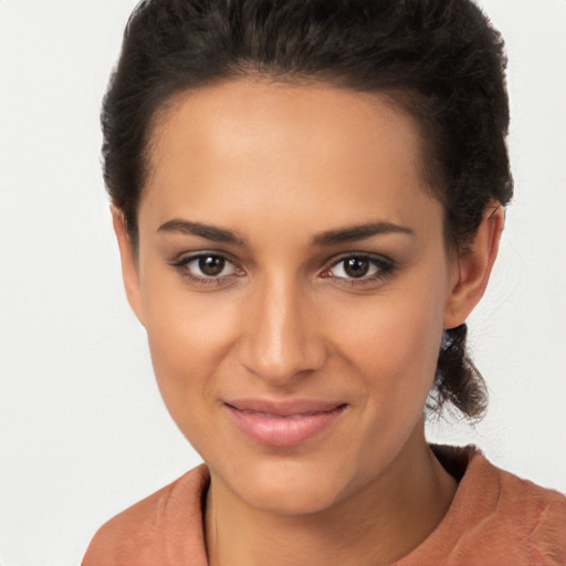 Joyful latino young-adult female with short  brown hair and brown eyes