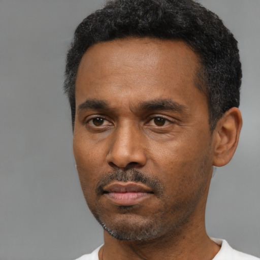 Neutral black young-adult male with short  black hair and brown eyes