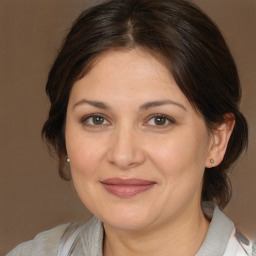 Joyful white adult female with medium  brown hair and brown eyes