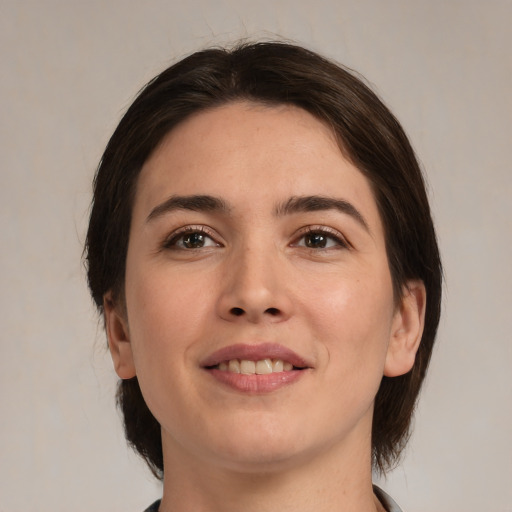 Joyful white young-adult female with medium  brown hair and brown eyes